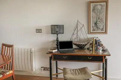 a desk with a laptop computer on top of it at Spindrift in Newquay