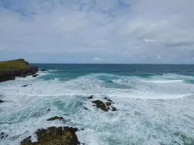 an aerial view of the ocean with rocks and waves at Spindrift in Newquay