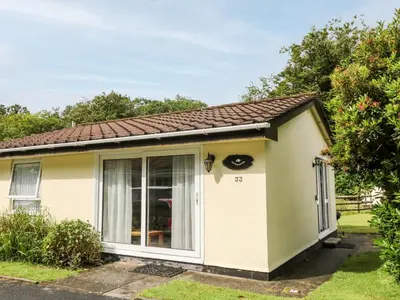 a small white cottage with a large window at Peacehaven in Liskeard
