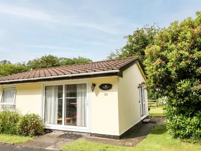 a small white cottage with a large window at Peacehaven in Liskeard