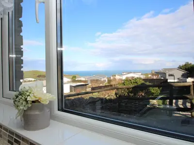 a window with a view of the ocean at Sunset Cottage in Tintagel