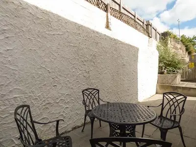 a table and chairs sitting on a patio at Kernow Cottage in Helston
