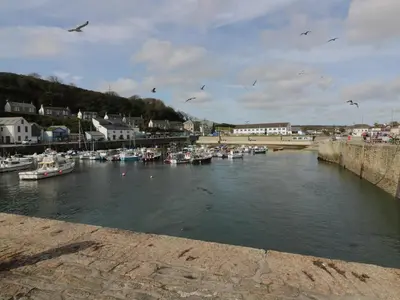 a group of boats are docked in a harbor at Kernow Cottage in Helston