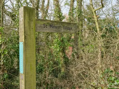 a wooden sign that reads st michael village at High Tide in Wadebridge