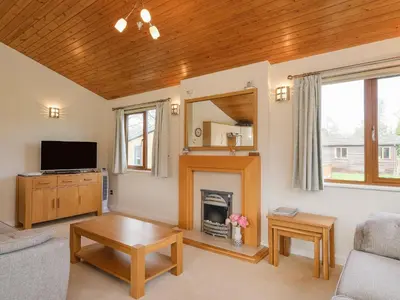 a living room with a fireplace and a tv at High Tide in Wadebridge