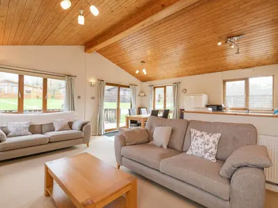 a living room with two couches and a table at High Tide in Wadebridge