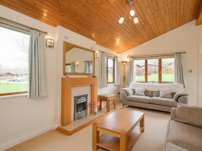 a living room with a couch and a fireplace at High Tide in Wadebridge