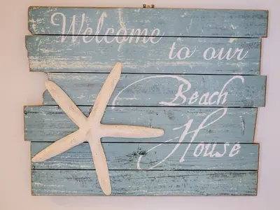a wooden sign with a starfish on a wall at Stone's Throw in Charlestown
