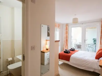 a bedroom with a bed and a bathroom at Stone's Throw in Charlestown