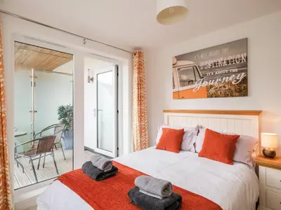 a bedroom with a bed with two hats on it at Stone's Throw in Charlestown