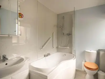a bathroom with a tub and a toilet and a sink at Shepherds Rest in Warbstow