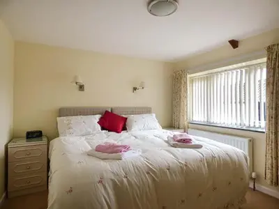 a bedroom with a bed with two pillows and a window at Shepherds Rest in Warbstow