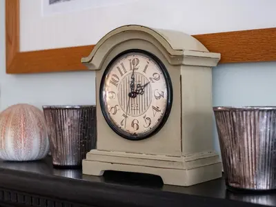 a small clock sitting on top of a shelf at Cobble Cottage in Boscastle