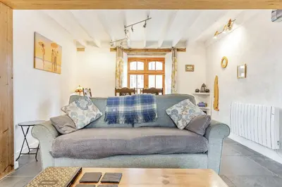 a living room with a couch and a table at Victoria Cottage in Newquay