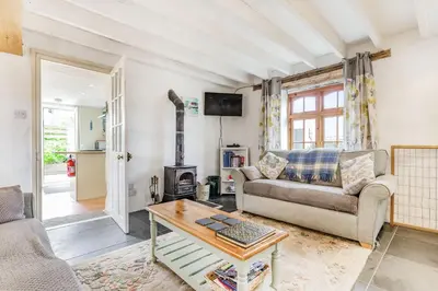 a living room with a couch and a table at Victoria Cottage in Newquay