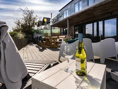 a bottle of wine sitting on a table with a wine glass at Chy Lowen in St Ives