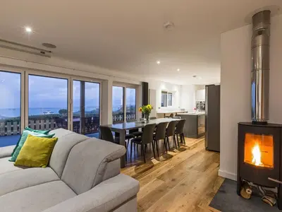 a living room with a couch and a wood stove at Chy Lowen in St Ives