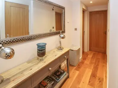 a bathroom with a vanity with a large mirror at Seafield in Carbis Bay