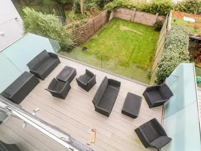 a group of chairs sitting on top of a deck at Seafield in Carbis Bay