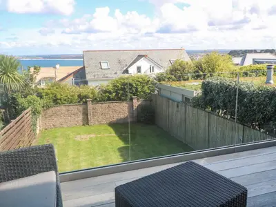 a balcony with a view of a yard at Seafield in Carbis Bay