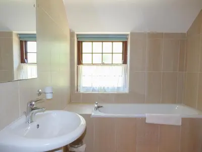 a bathroom with a sink and a bath tub at The Granary in Saint Erth