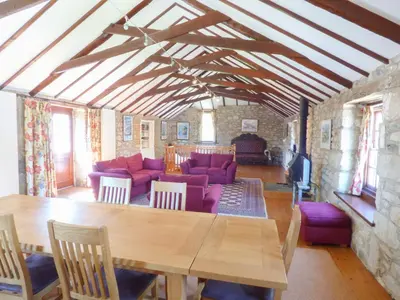 a living room with a table and a couch at The Granary in Saint Erth