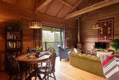 a living room with a table and a couch at Kingfisher Cabin, Butterwell Farm, Riverside cabin on 40-acre private estate in Bodmin