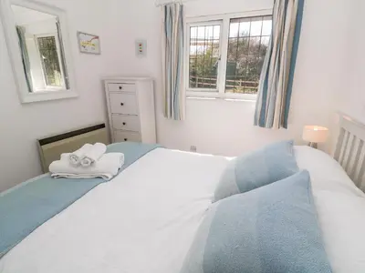a bedroom with a bed with towels on it at Rockpool in Padstow