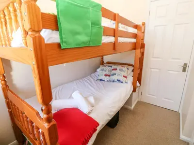 a bunk bed in a room with a red pillow at Rockpool in Padstow