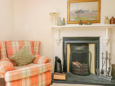a living room with a couch and a fireplace at Goshen Farm in St. Agnes