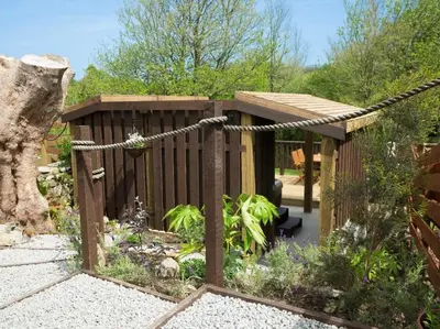 a garden with a wooden fence and a woodenificialificialificialificialificialificialificial at Godrevy Cottage in Hayle