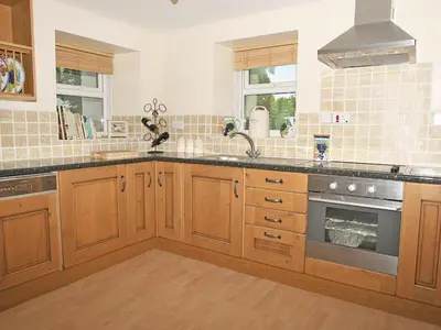 a kitchen with a sink and a stove at Godrevy Cottage in Hayle