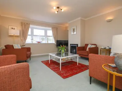 a living room with couches and a coffee table at Sea Star in Porthleven