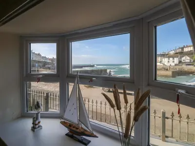 a window with a view of the beach and the ocean at Sea Star in Porthleven