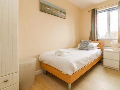 a bedroom with a bed and a window at Pentewan in Hayle