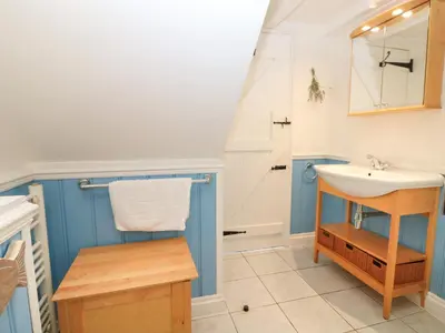 a bathroom with a sink and a mirror at Trehan in St Ives