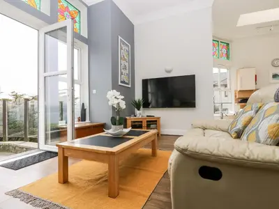 a living room with a couch and a coffee table at By The Sea in Newquay