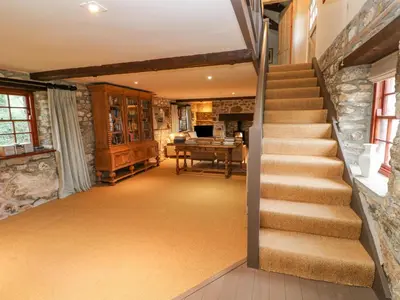 a staircase in a home with a stone wall at Barn Cottage in Saint Erth