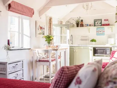 a kitchen with a counter and a table in a room at The Snug in Bugle