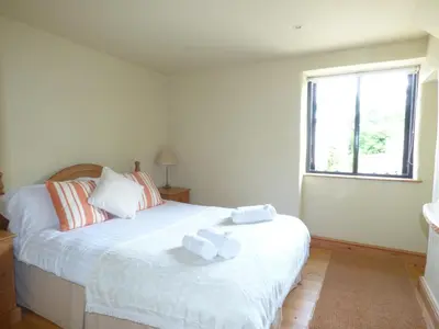 a bedroom with two beds with towels on them at Meadow Cottage in Fowey