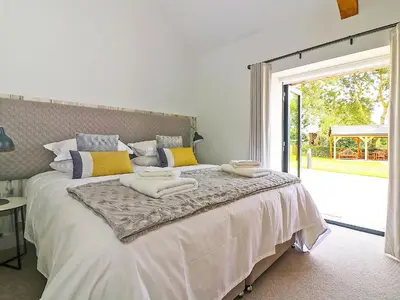 a bedroom with a bed with towels on it at The Stable, Boskensoe Barns in Falmouth