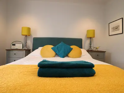 a bed with two pillows on top of it at The Snug in Grampound