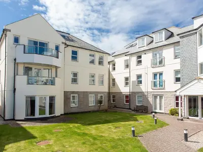 an apartment building with a lawn in front of it at Cribbar View in Newquay