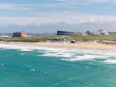 a view of a beach with buildings and the ocean at Cribbar View in Newquay
