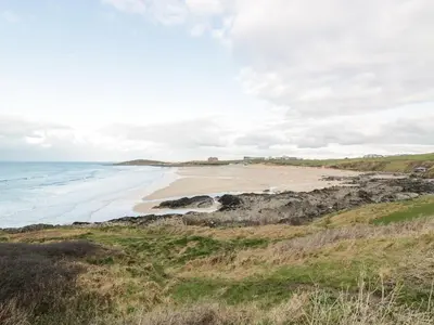 a view of a beach from a hill with the ocean at Cribbar View in Newquay