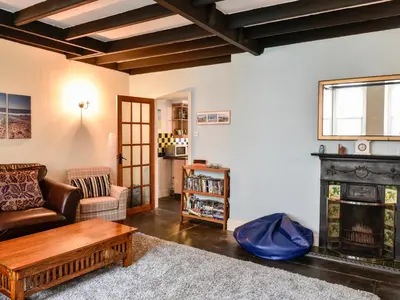 a living room with a couch and a fireplace at Tower House in Boscastle