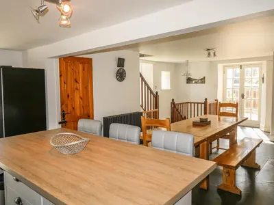 a kitchen and dining room with a table and chairs at Tower House in Boscastle