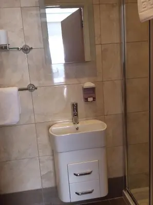 a bathroom with a sink and a shower at Beechwood House in St Ives