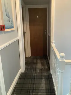 a hallway with a door and a tile floor at Beechwood House in St Ives