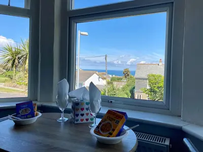 a table with food and a window with a view at Beechwood House in St Ives